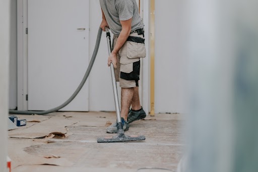 a person cleaning a new refurbished room.