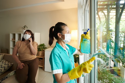 Cleaning person washing windows.