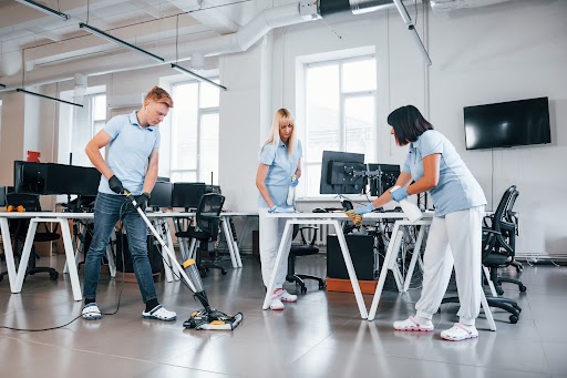 a group of cleaners cleaning an office